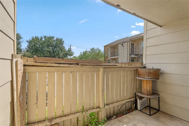 a backyard of a house with chairs