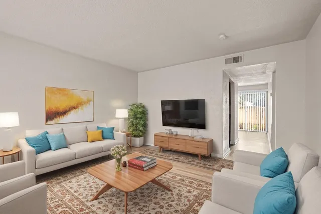 a living room with furniture and a flat screen tv