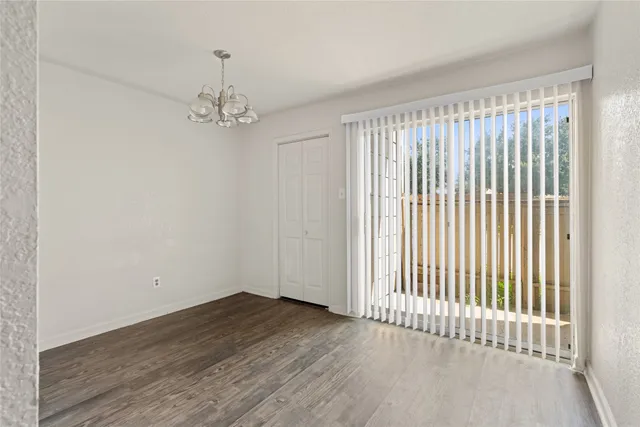 a view of a livingroom with wooden floor and a window