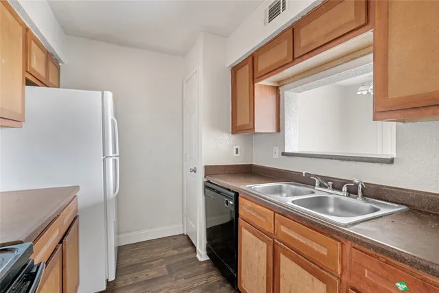 a kitchen with a sink stove and refrigerator