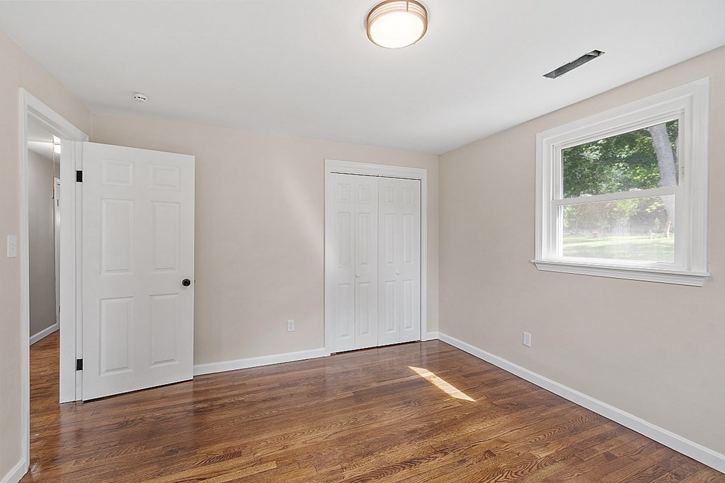 621 Boston Road Billerica, MA 01821 - Photo 12 of 27 a view of an empty room with wooden floor and a window