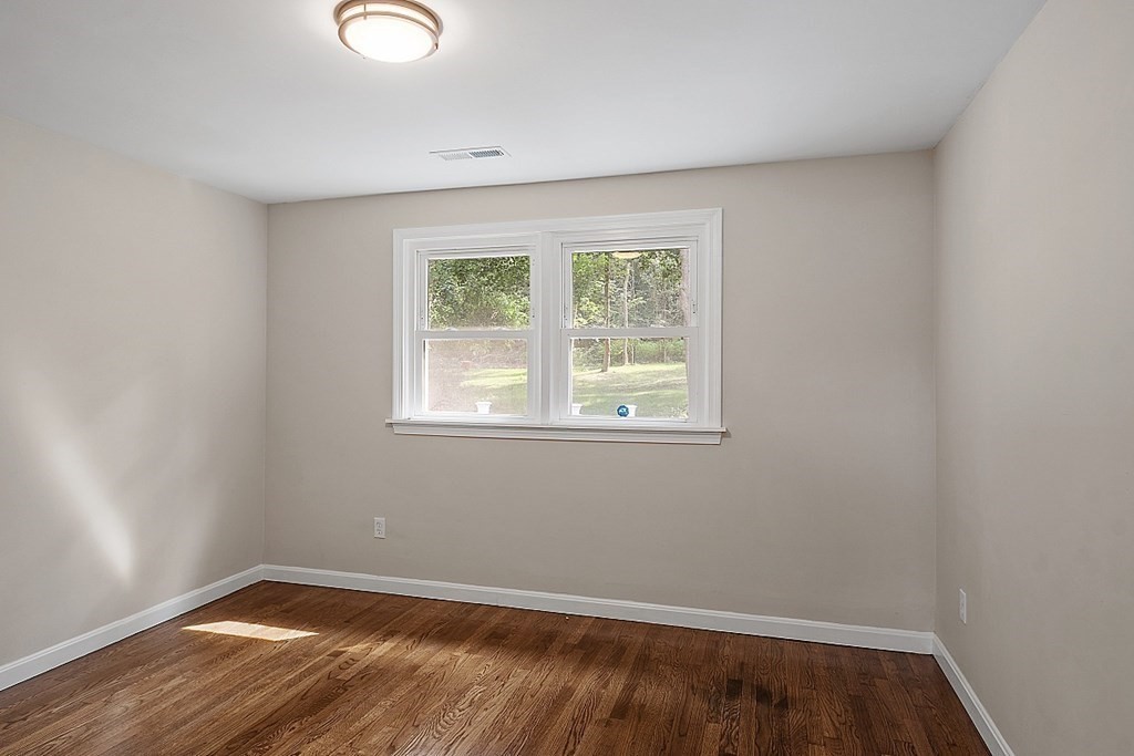 621 Boston Road Billerica, MA 01821 - Photo 13 of 27 an empty room with wooden floor and windows