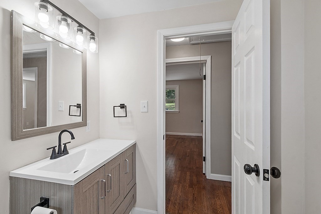 621 Boston Road Billerica, MA 01821 - Photo 16 of 27 a bathroom with a sink a mirror and shower