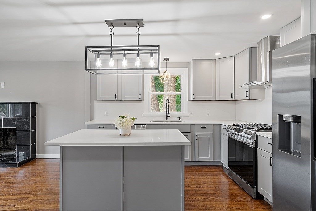 621 Boston Road Billerica, MA 01821 - Photo 2 of 27 a kitchen with a sink stainless steel appliances cabinets and a counter top space