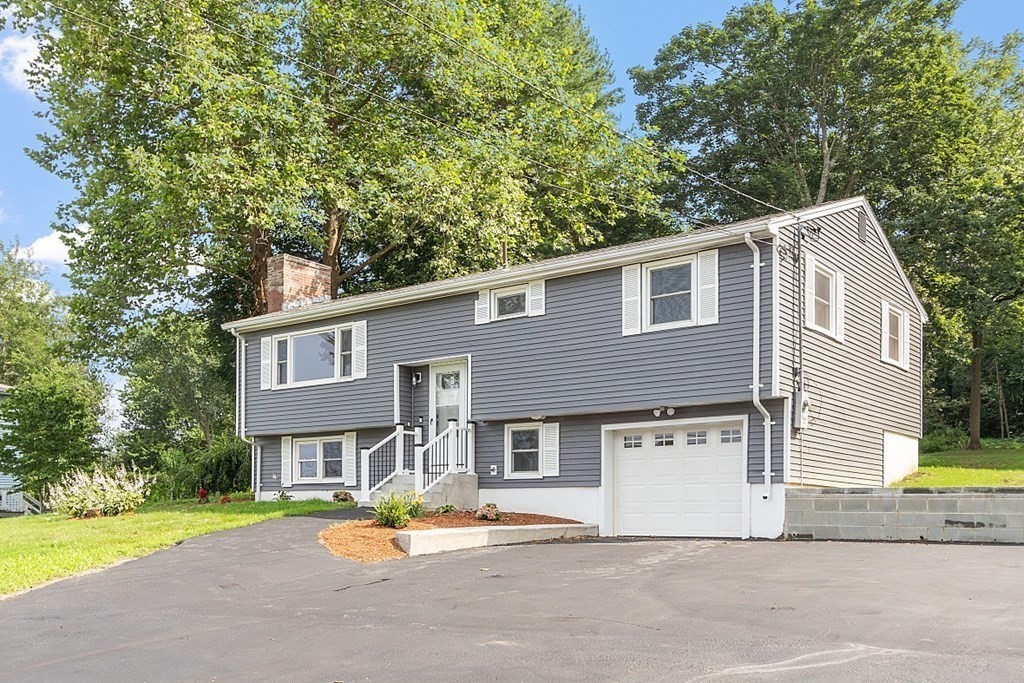 621 Boston Road Billerica, MA 01821 - Photo 21 of 27 a front view of a house with a yard and garage