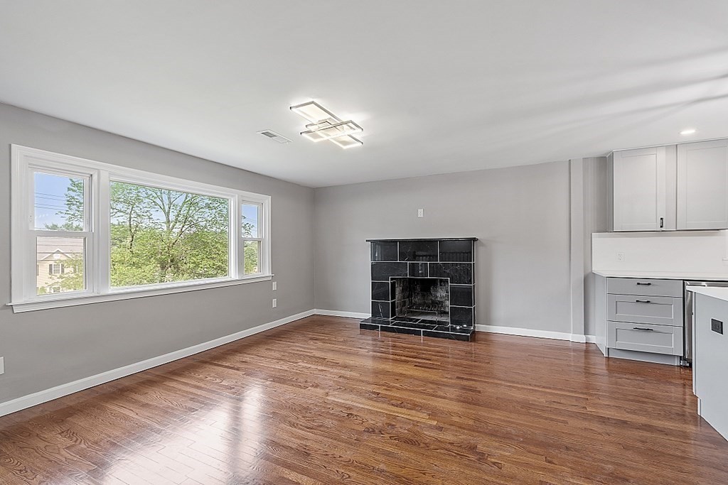 621 Boston Road Billerica, MA 01821 - Photo 6 of 27 a view of empty room with wooden floor and windows