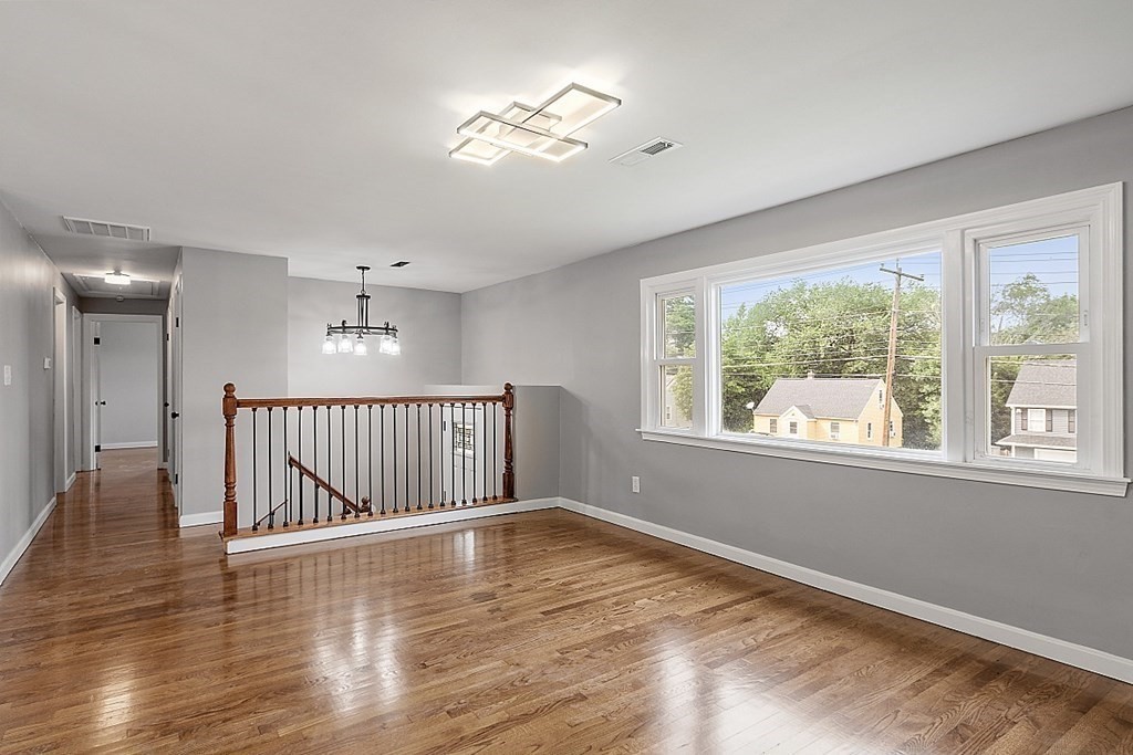 621 Boston Road Billerica, MA 01821 - Photo 7 of 27 a view of an empty room with wooden floor and a window
