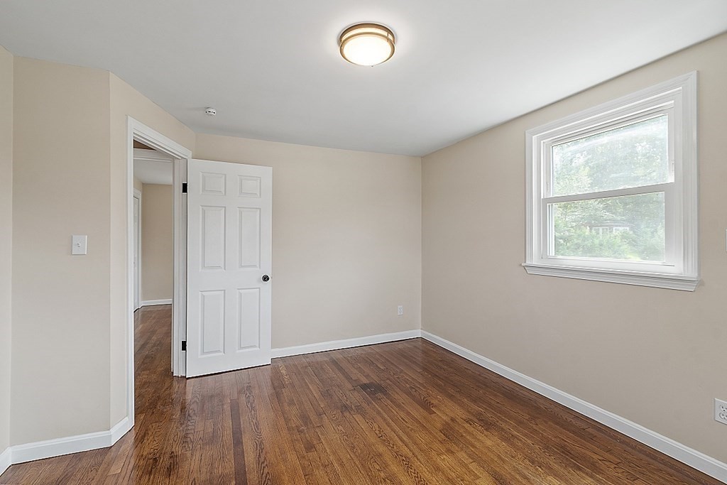 621 Boston Road Billerica, MA 01821 - Photo 9 of 27 an empty room with wooden floor and windows