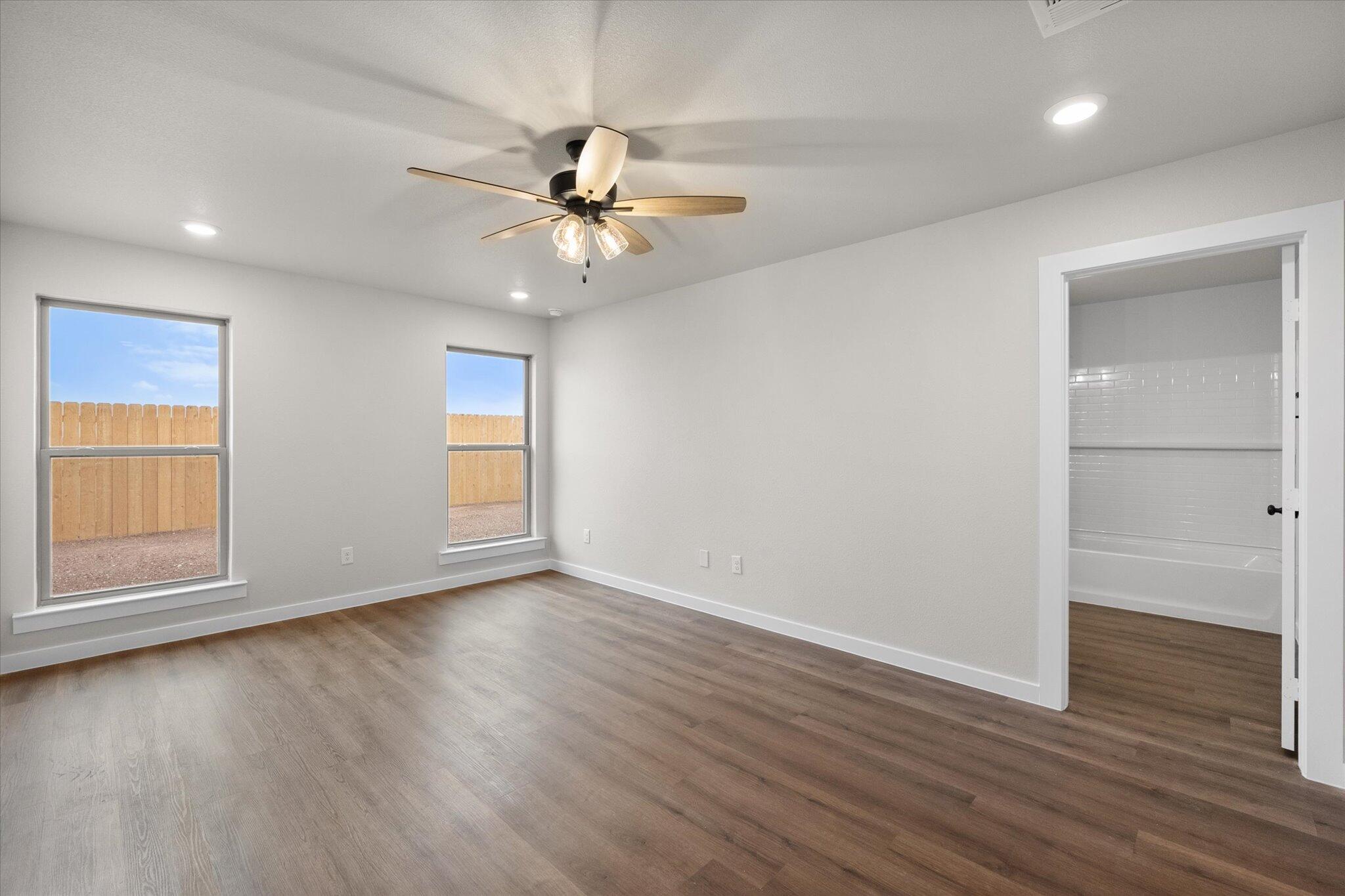 3022 140th Street Lubbock, TX 79423 - Photo 13 of 20 a view of an empty room with wooden floor and a window