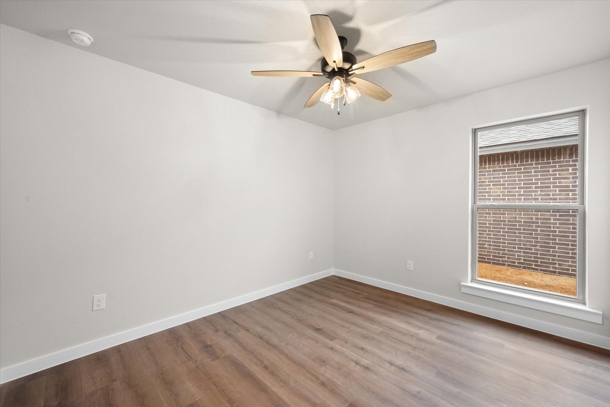 3022 140th Street Lubbock, TX 79423 - Photo 16 of 20 wooden floor in an empty room with a window