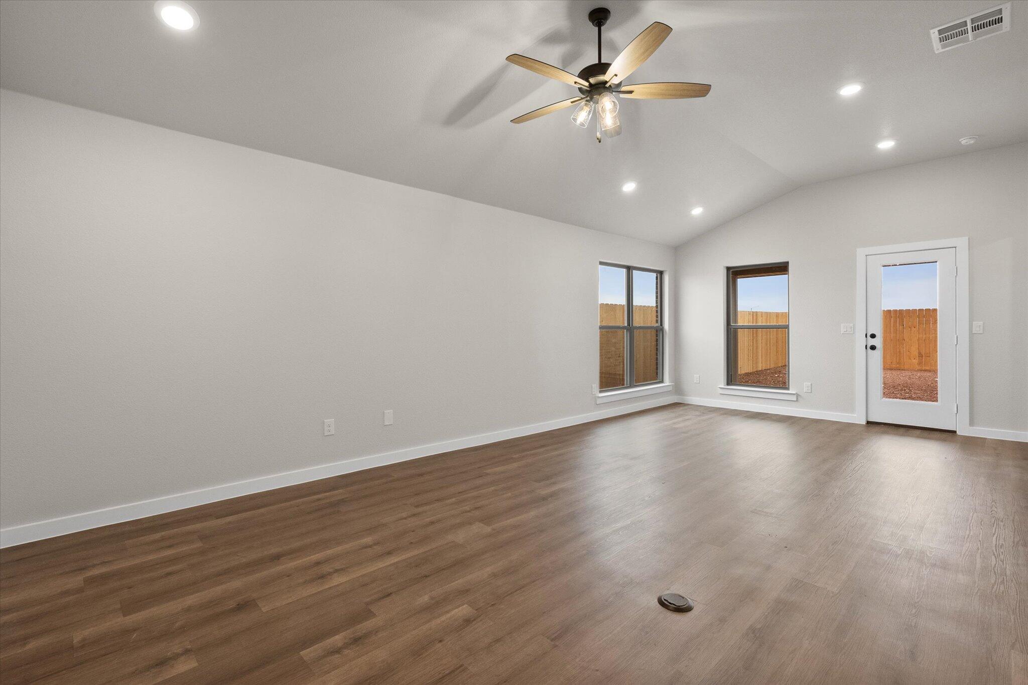 3022 140th Street Lubbock, TX 79423 - Photo 3 of 20 a view of an empty room with window and wooden floor