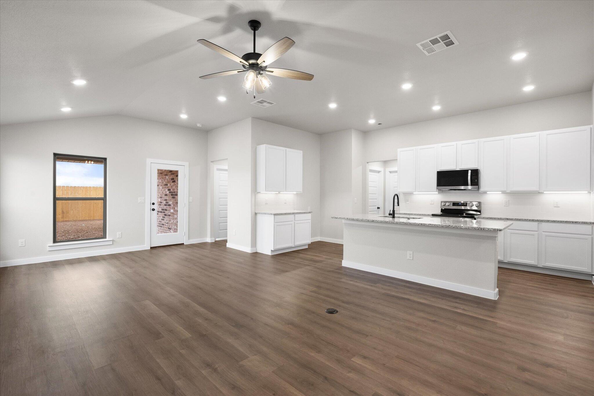 3022 140th Street Lubbock, TX 79423 - Photo 4 of 20 a view of kitchen with sink microwave and stove