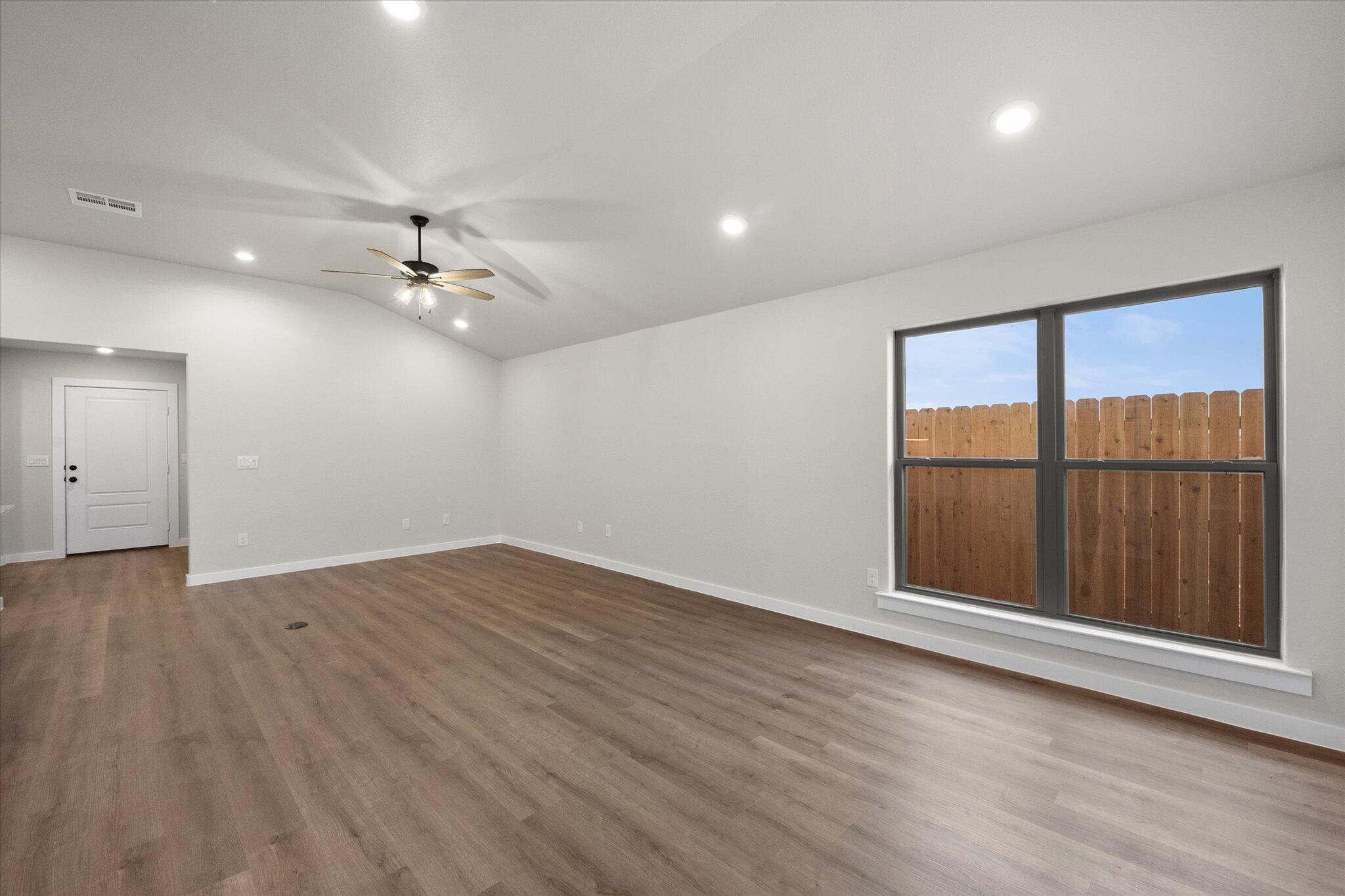 3022 140th Street Lubbock, TX 79423 - Photo 6 of 20 wooden floor in an empty room with a window
