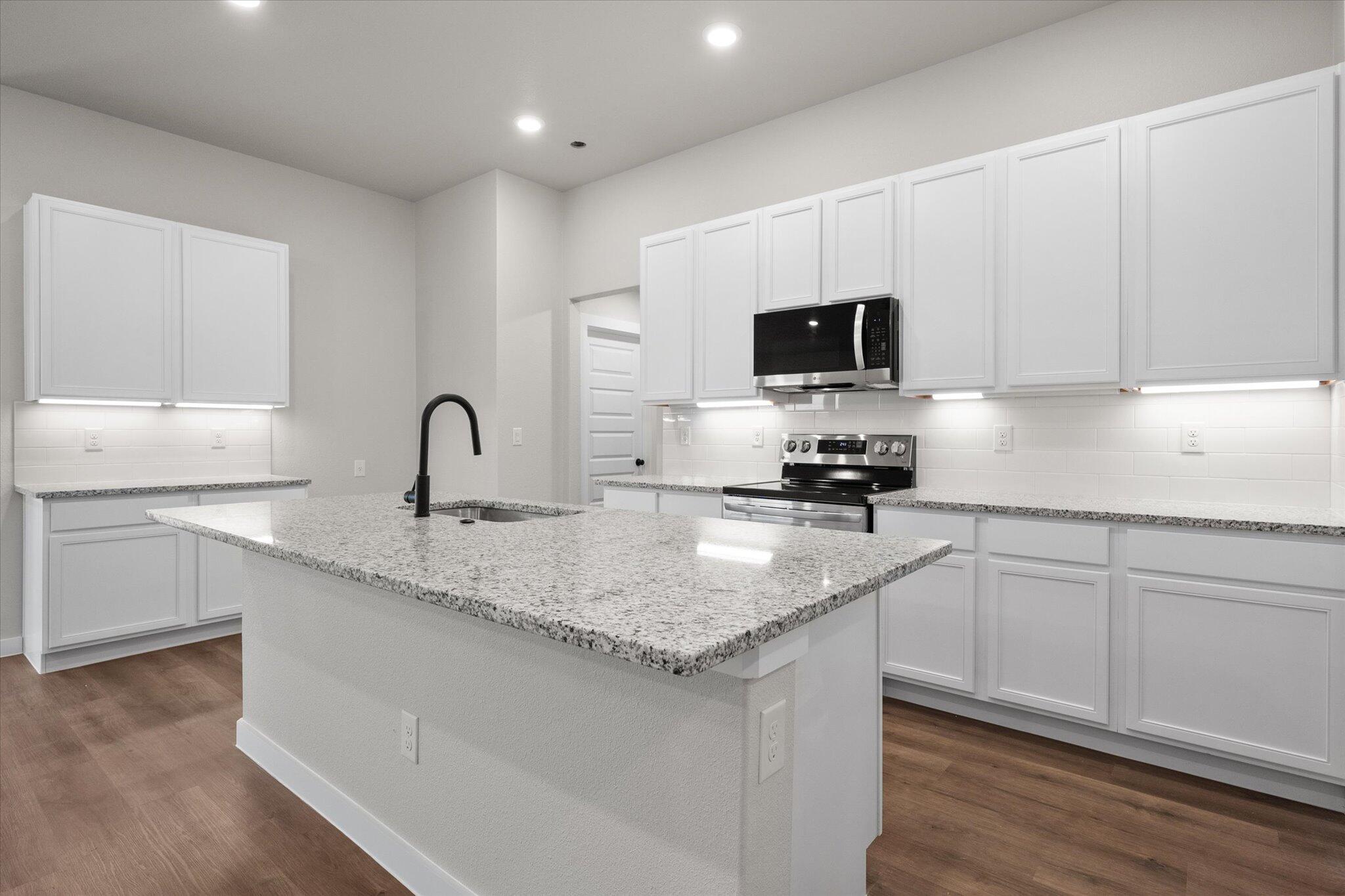 3022 140th Street Lubbock, TX 79423 - Photo 9 of 20 a kitchen with a sink stove and microwave