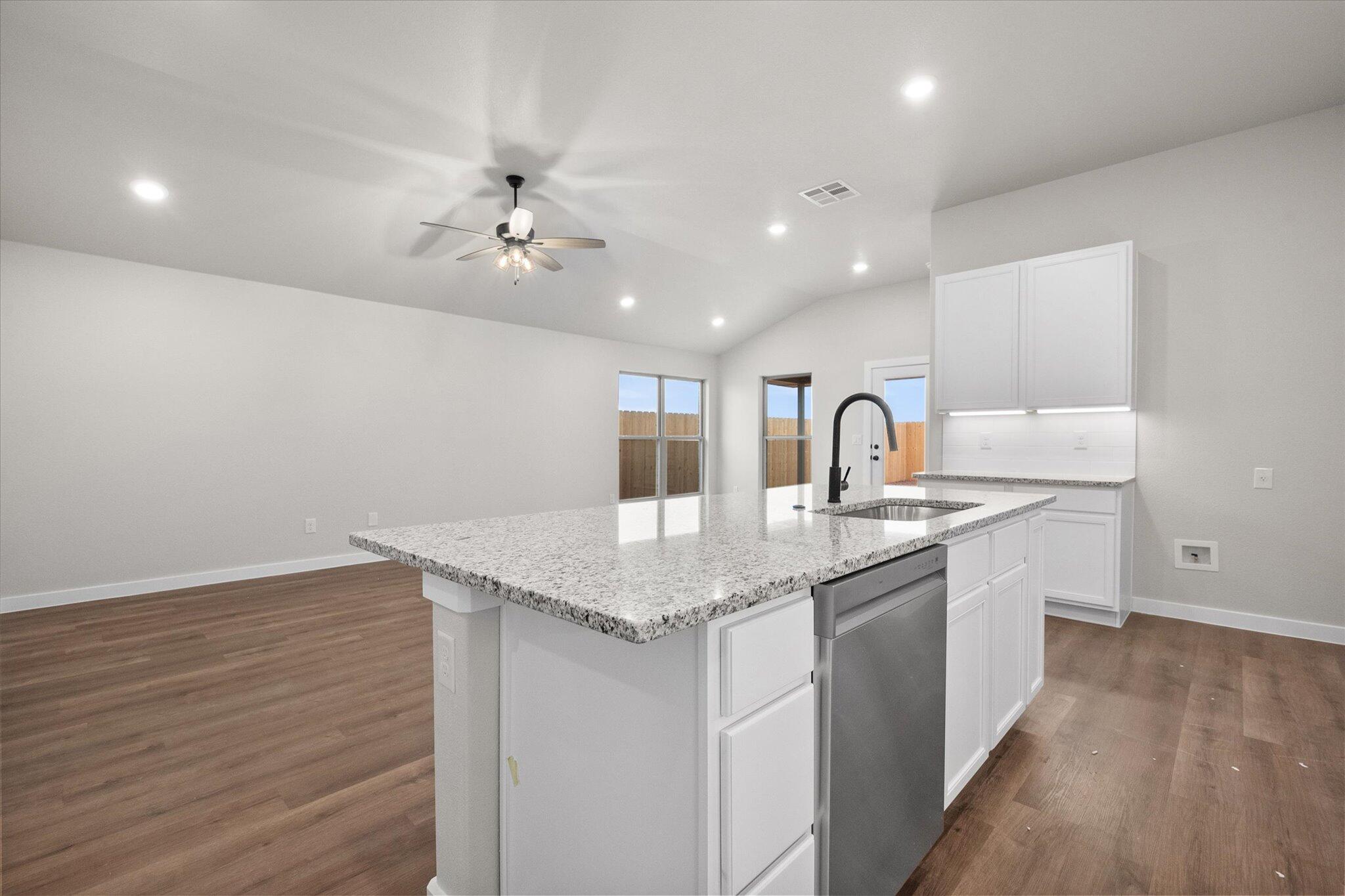 3022 140th Street Lubbock, TX 79423 - Photo 10 of 20 a kitchen with a sink cabinets and wooden floor