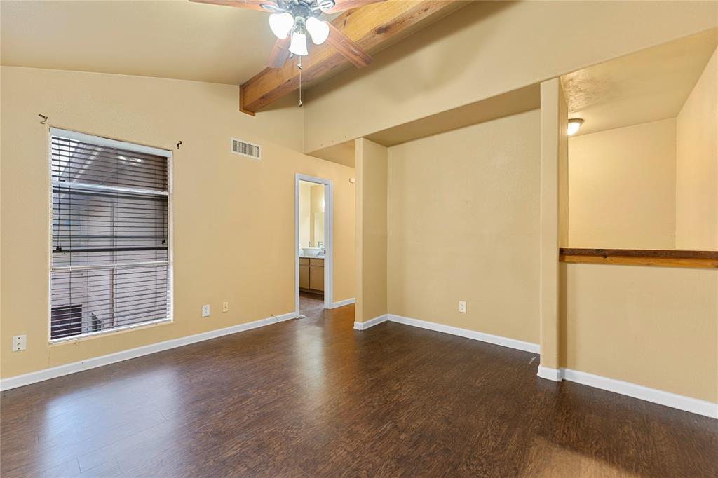 5516 Boca Raton Boulevard, Unit 310 Fort Worth, TX 76112 - Photo 11 of 19 a view of an empty room with wooden floor and a window