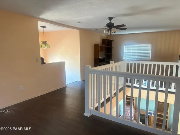 a view of a room with wooden floor and windows