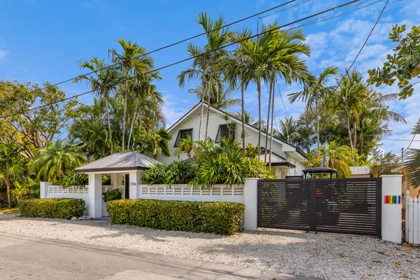 a house that has a palm tree in front of it