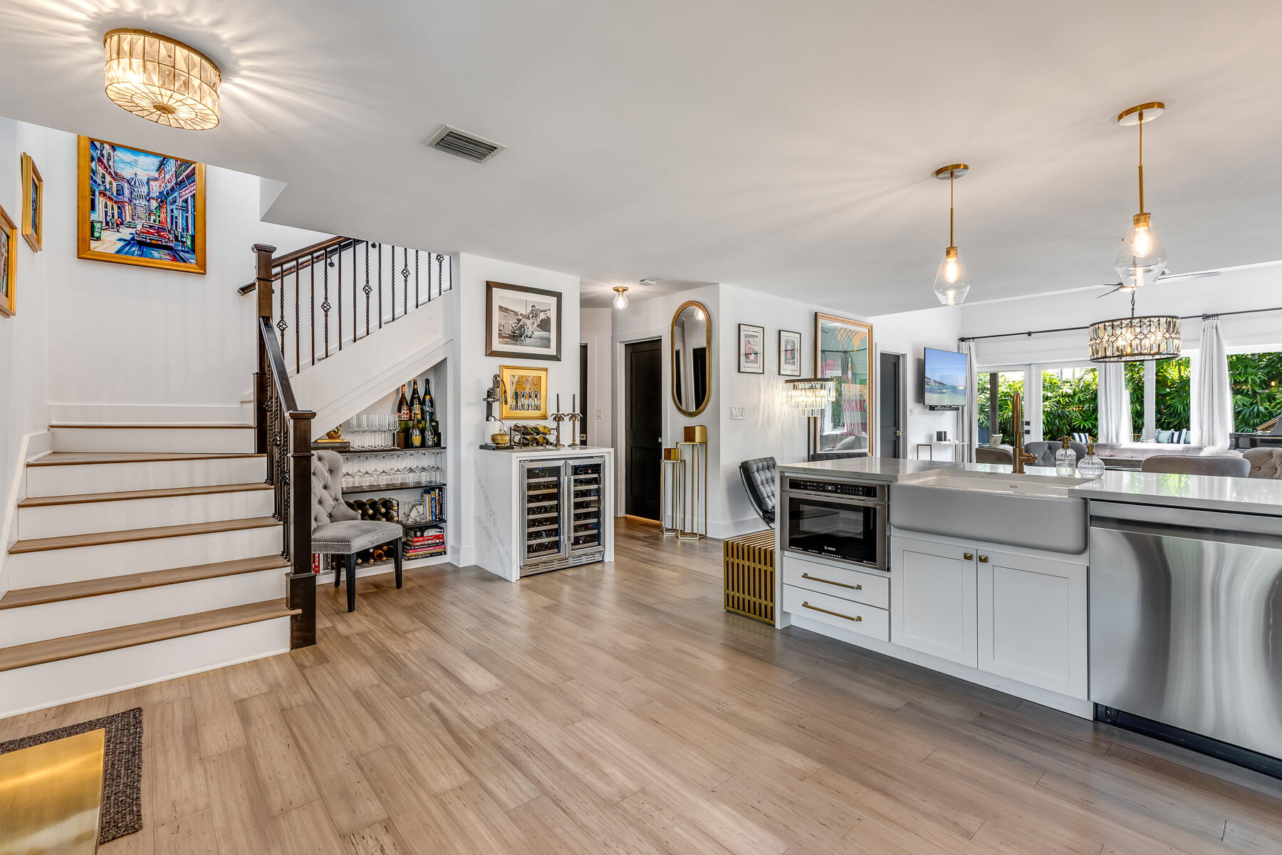 1708 Laird Street Key West, FL 33040 - Photo 11 of 43 a kitchen with stainless steel appliances granite countertop a refrigerator oven a stove and a dining table with wooden floor