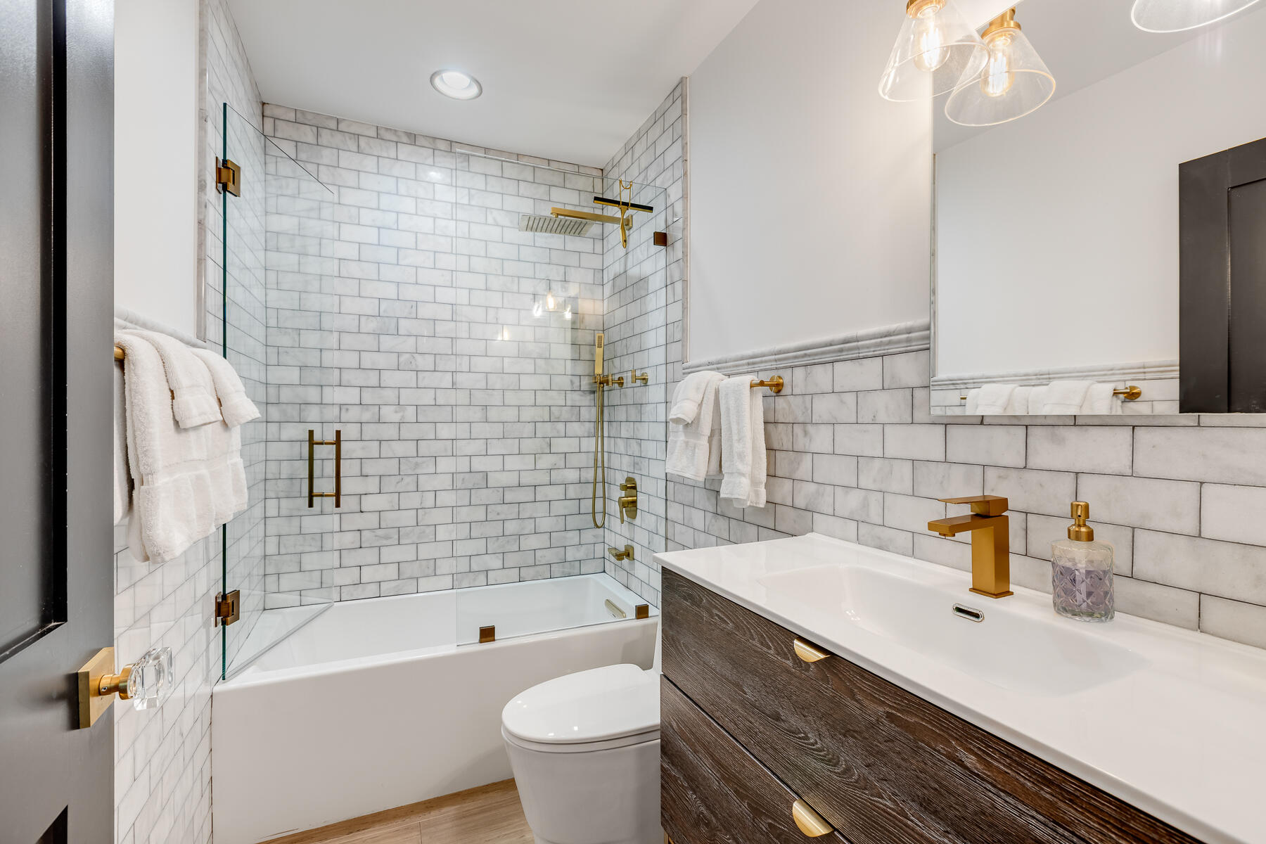 1708 Laird Street Key West, FL 33040 - Photo 17 of 43 a bathroom with a sink a toilet a mirror a vanity and bathtub