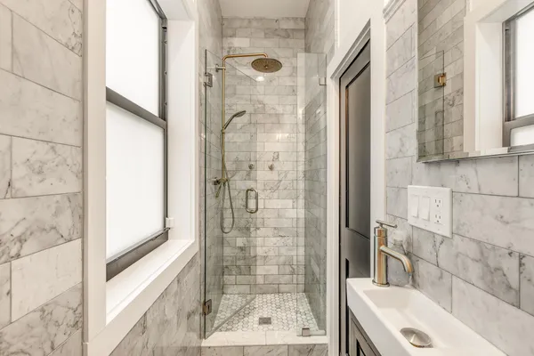 a bathroom with a shower and a sink