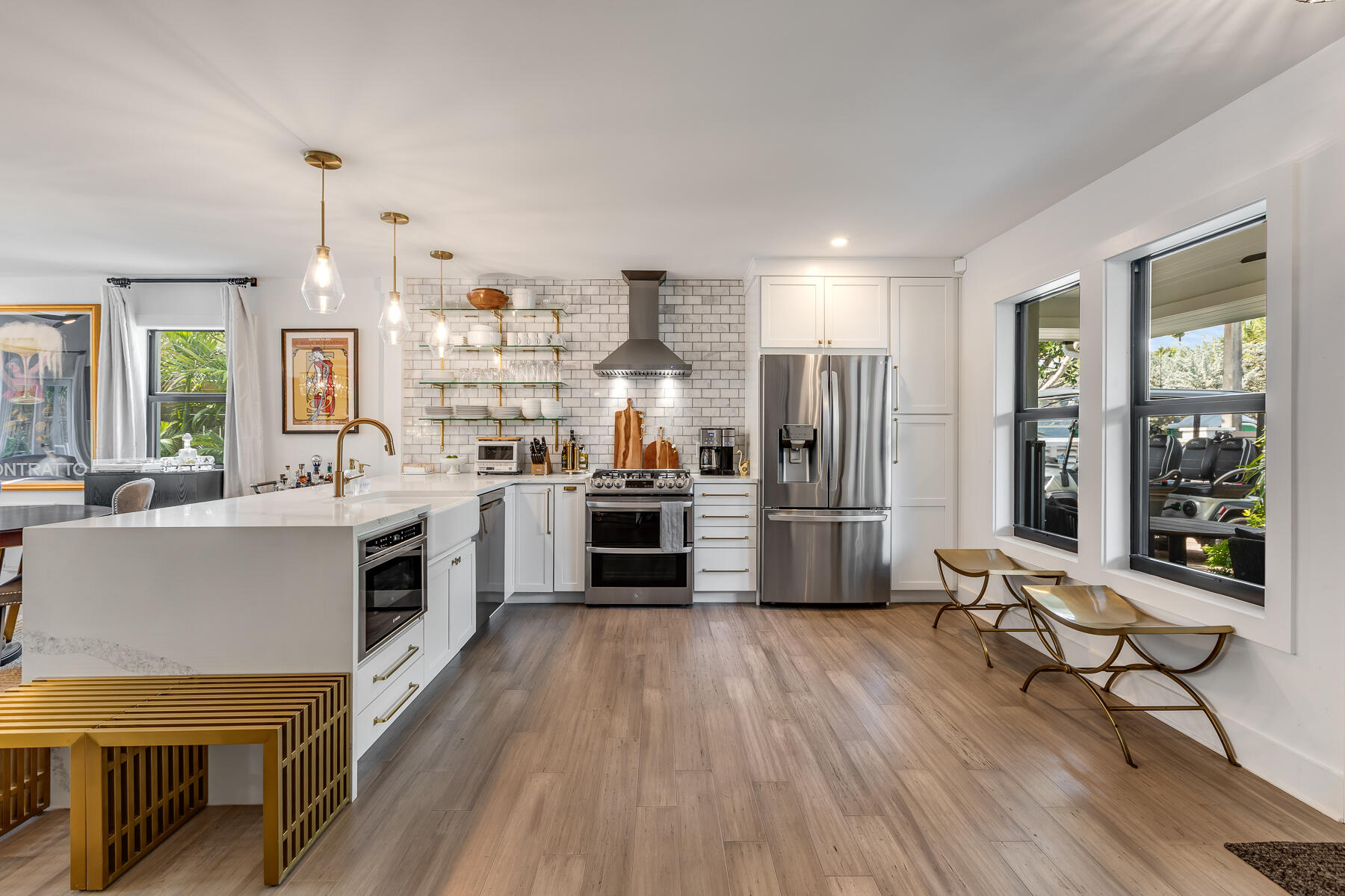1708 Laird Street Key West, FL 33040 - Photo 20 of 43 a kitchen with stainless steel appliances a stove top oven a sink dishwasher a dining table and chairs with wooden floor