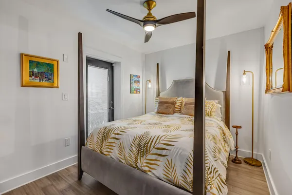 a bedroom with a bed and a chandelier