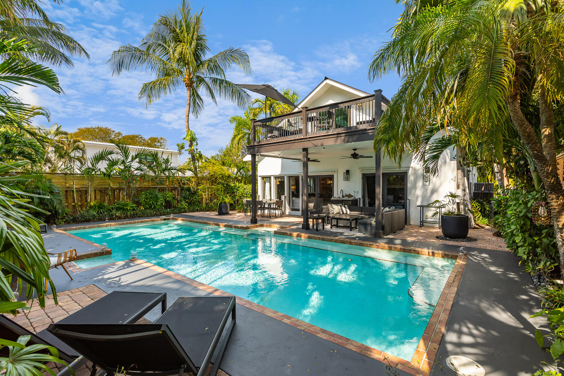 1708 Laird Street Key West, FL 33040 - Photo 22 of 43 a view of a patio with table and chairs potted plants and palm trees