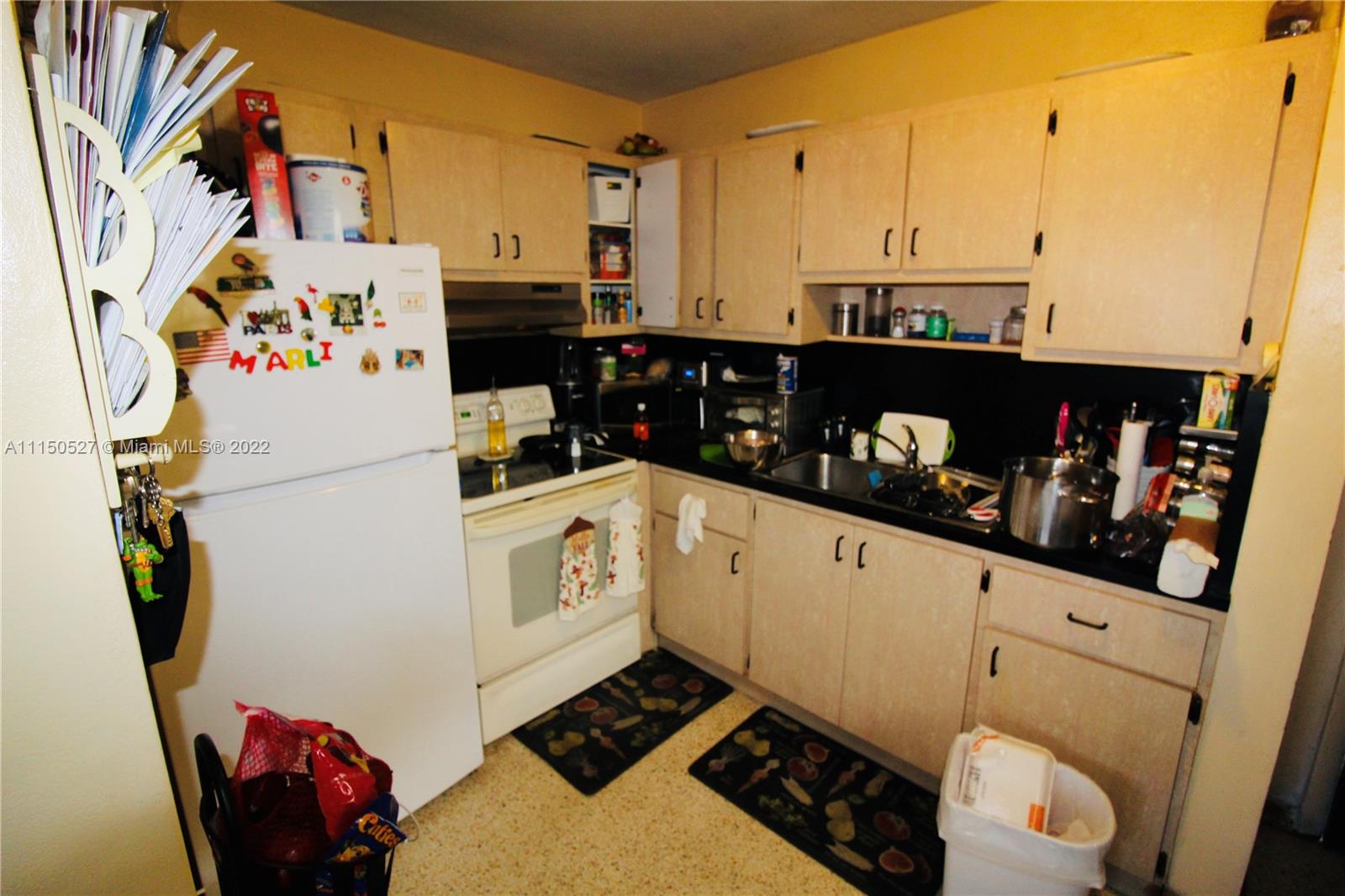 46 Northwest 35th Street Miami, FL 33127 - Photo 17 of 21 a kitchen with a refrigerator and a stove