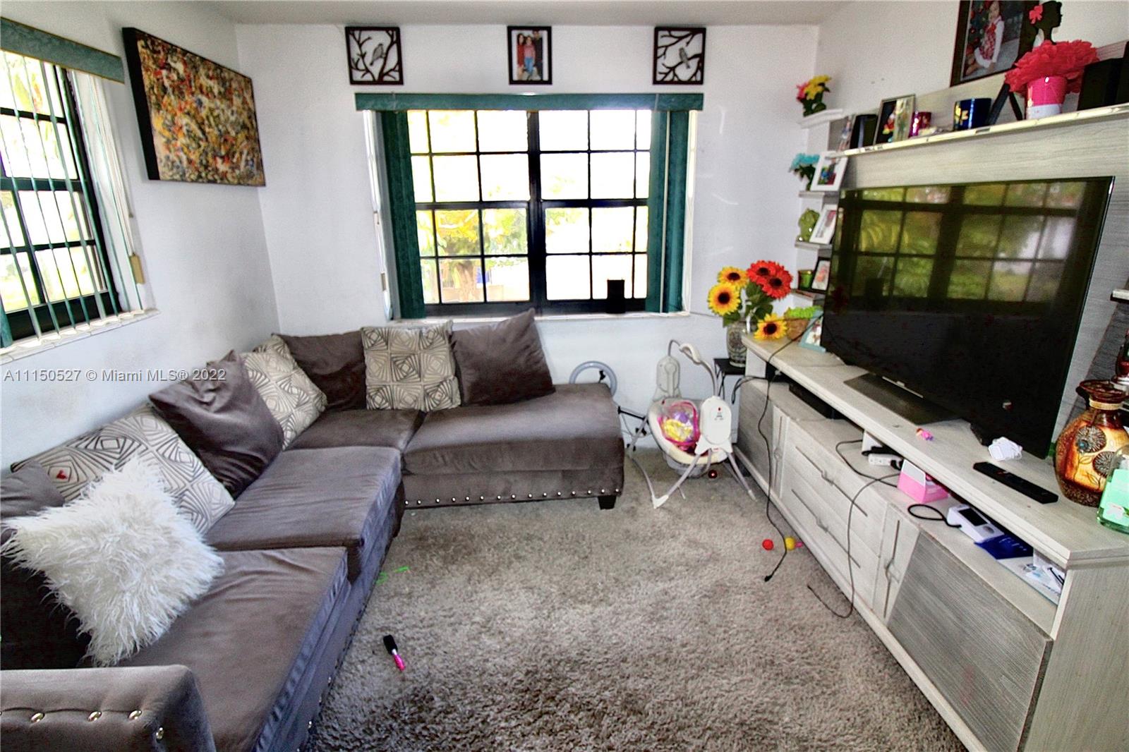 46 Northwest 35th Street Miami, FL 33127 - Photo 18 of 21 a living room with furniture and a flat screen tv