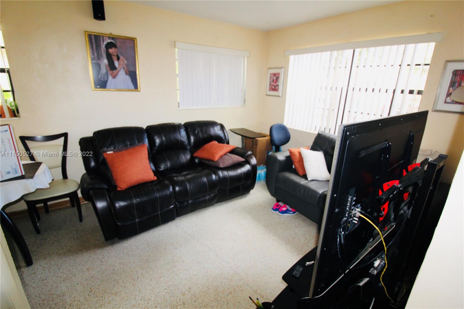 46 Northwest 35th Street Miami, FL 33127 - Photo 7 of 21 a living room with furniture a flat screen tv and a window