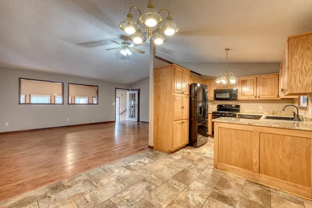 a view of a kitchen with a sink and a refrigerator