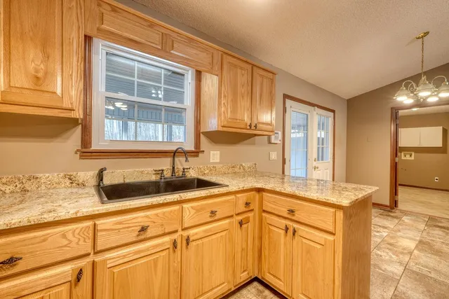 a kitchen with stainless steel appliances granite countertop a sink and a cabinets