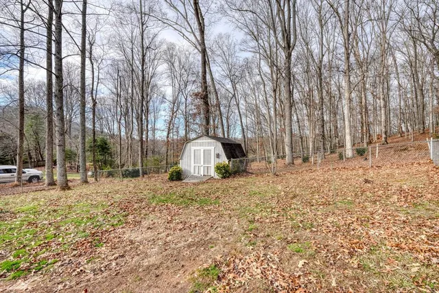 a view of a covered with snow on the wall and covered with tall trees