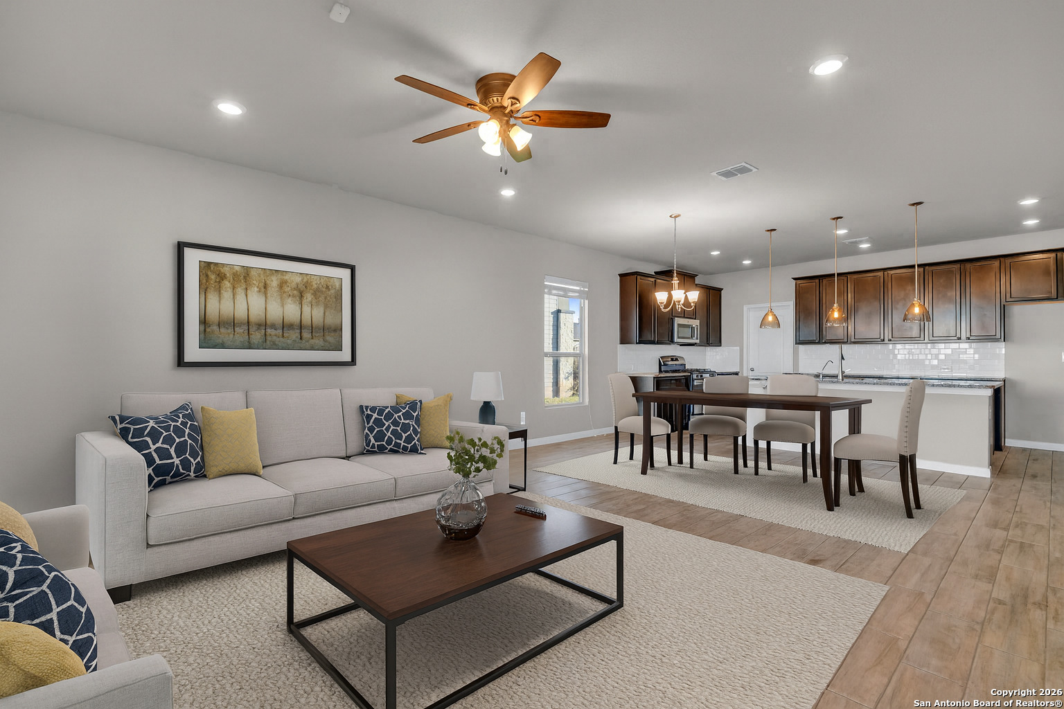 a living room with furniture kitchen view and a dining table