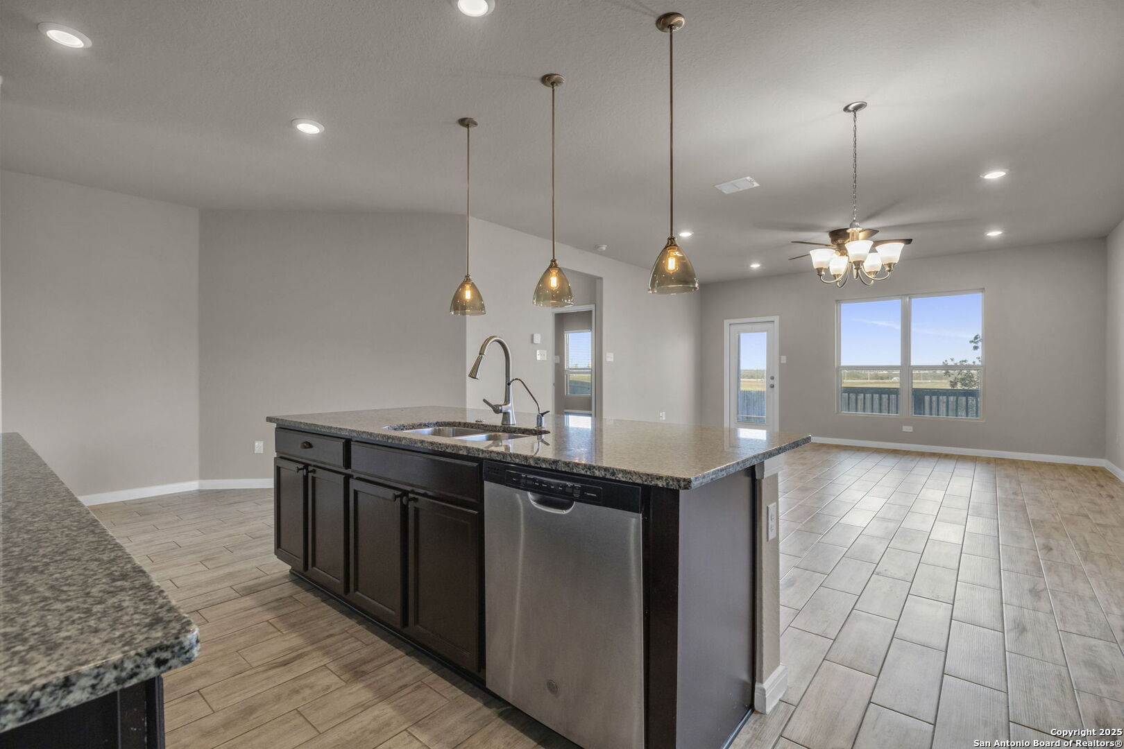 10411 Francisco Way Converse, TX 78109 - Photo 11 of 25 a kitchen with kitchen island a sink appliances and a counter top space