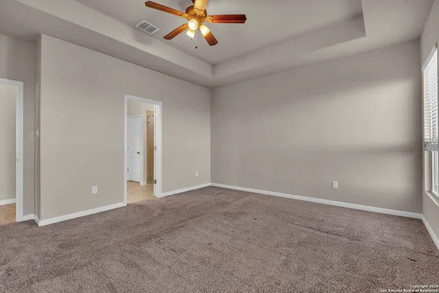 a view of an empty room with a fan