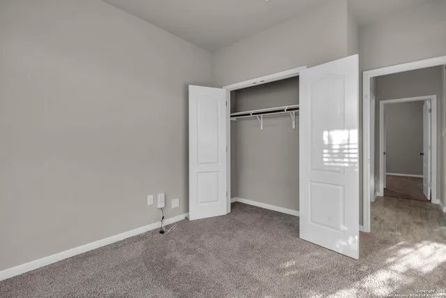 an empty room with closet area