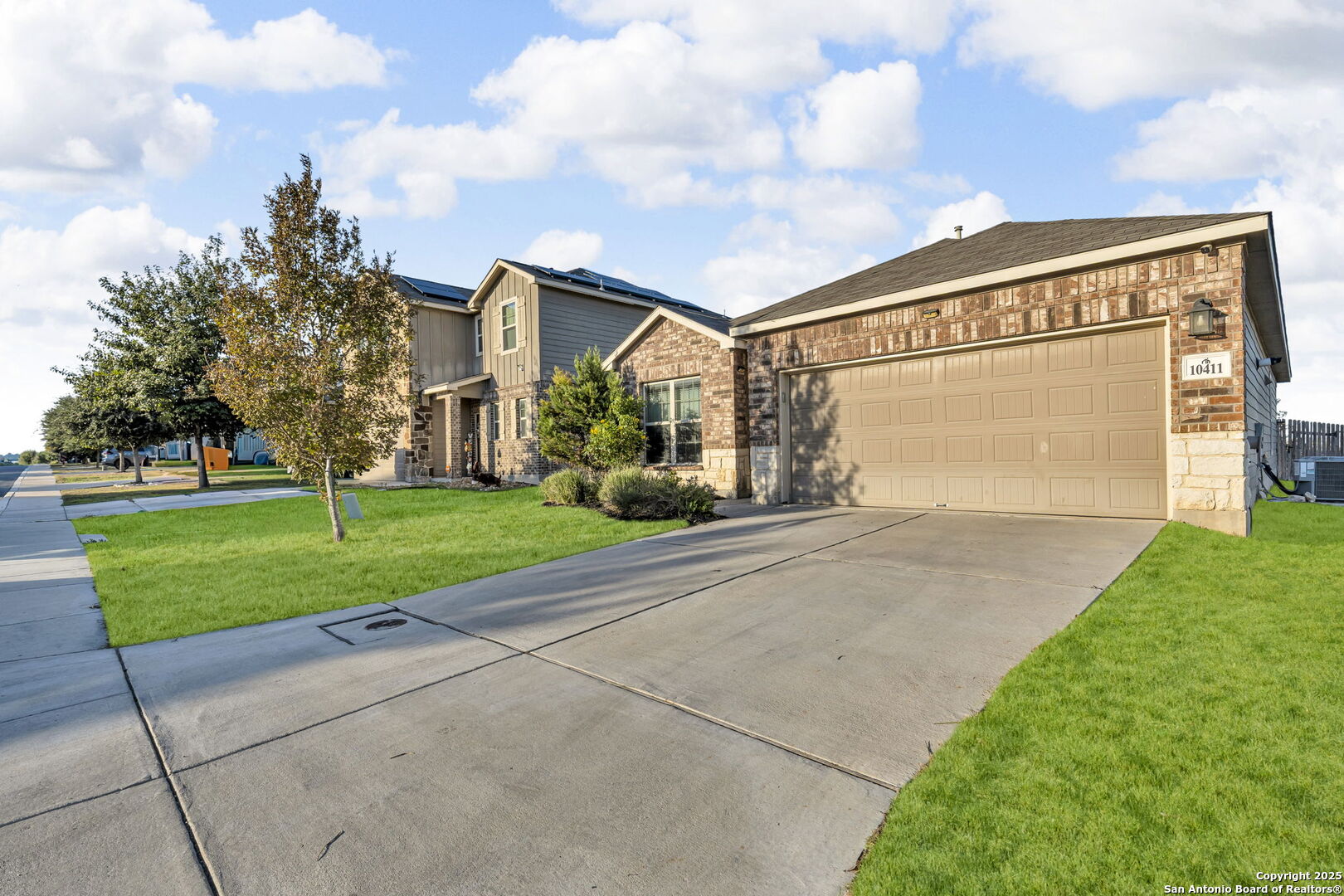 10411 Francisco Way Converse, TX 78109 - Photo 2 of 25 a front view of a house with a yard and garage