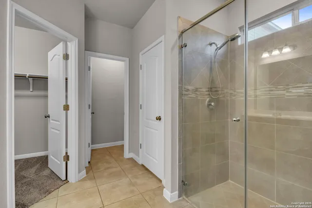 a bathroom with a shower and a sink