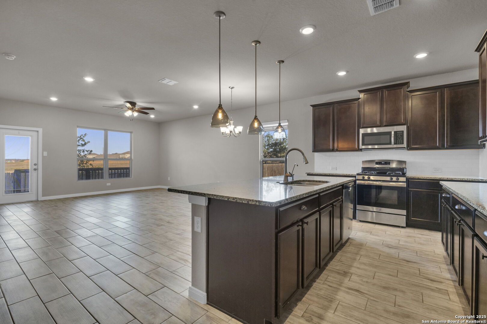 10411 Francisco Way Converse, TX 78109 - Photo 10 of 25 a kitchen with stainless steel appliances granite countertop a refrigerator a sink a stove and oven