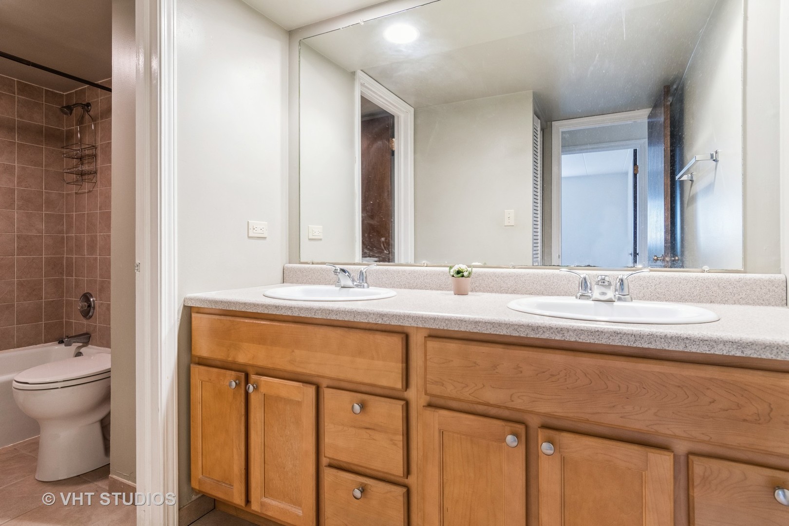 214 East Bailey Road, Unit B Naperville, IL 60565 - Photo 8 of 10 a bathroom with a double vanity sink toilet and a mirror