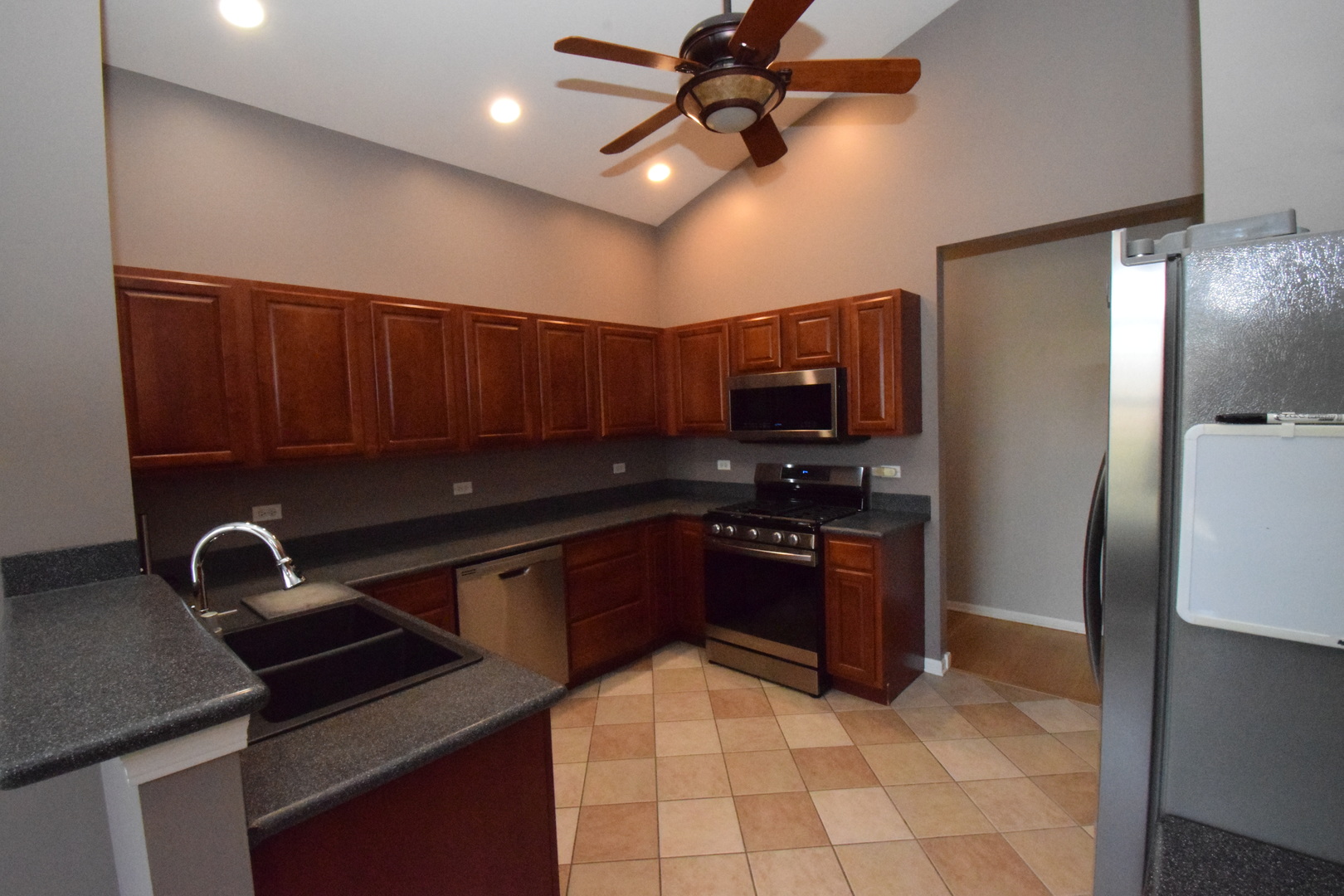 600 Countryfield Lane Elgin, IL 60120 - Photo 15 of 31 a kitchen with stainless steel appliances granite countertop a sink a stove a refrigerator and island