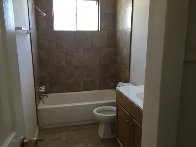 a bathroom with a toilet and a bathtub