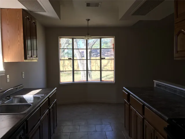 a kitchen with a sink a stove and a window