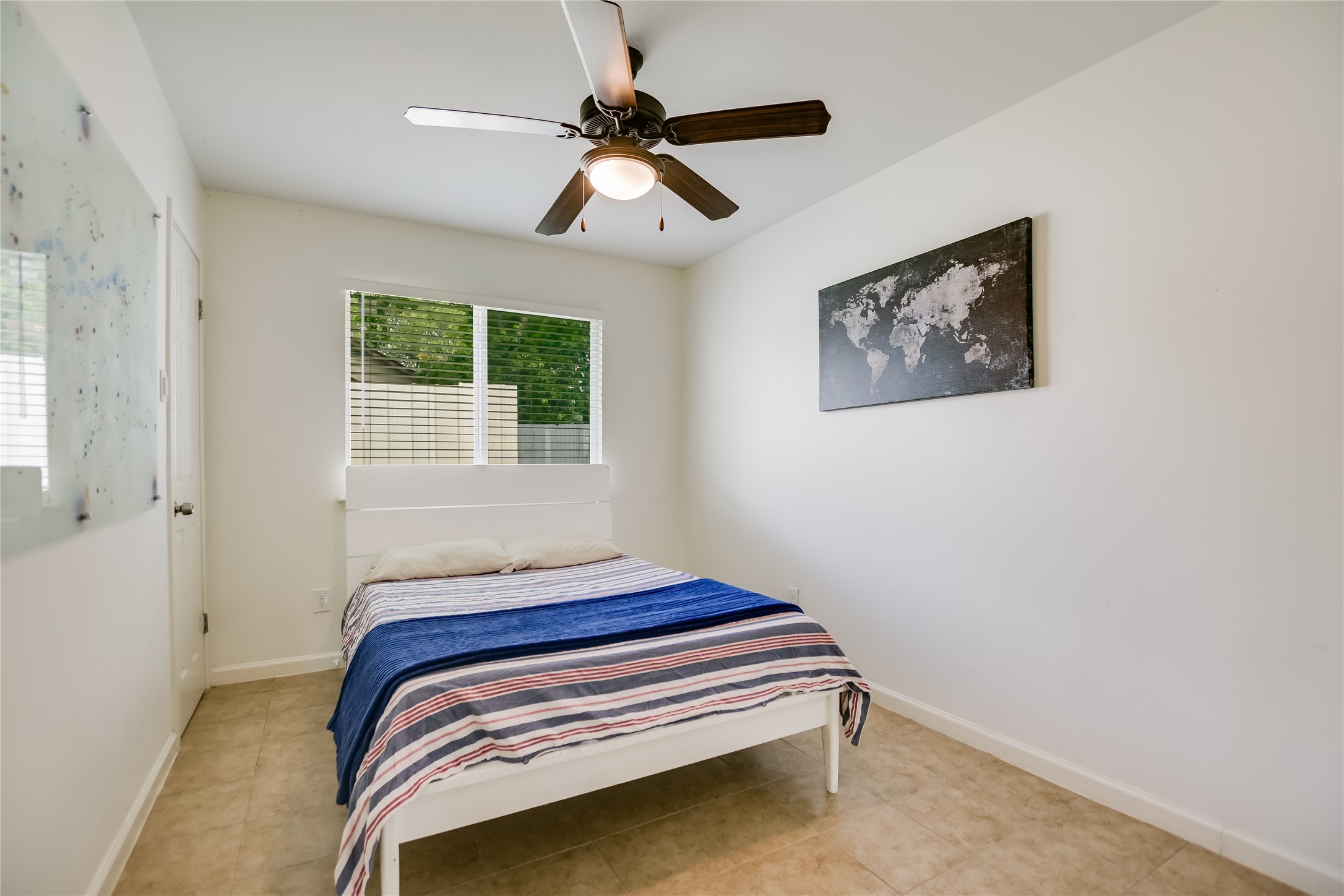 4702 Crest Oak Road Austin, TX 78744 - Photo 12 of 20 Bright room featuring a window with blinds, a ceiling fan with integrated lighting, and tile flooring