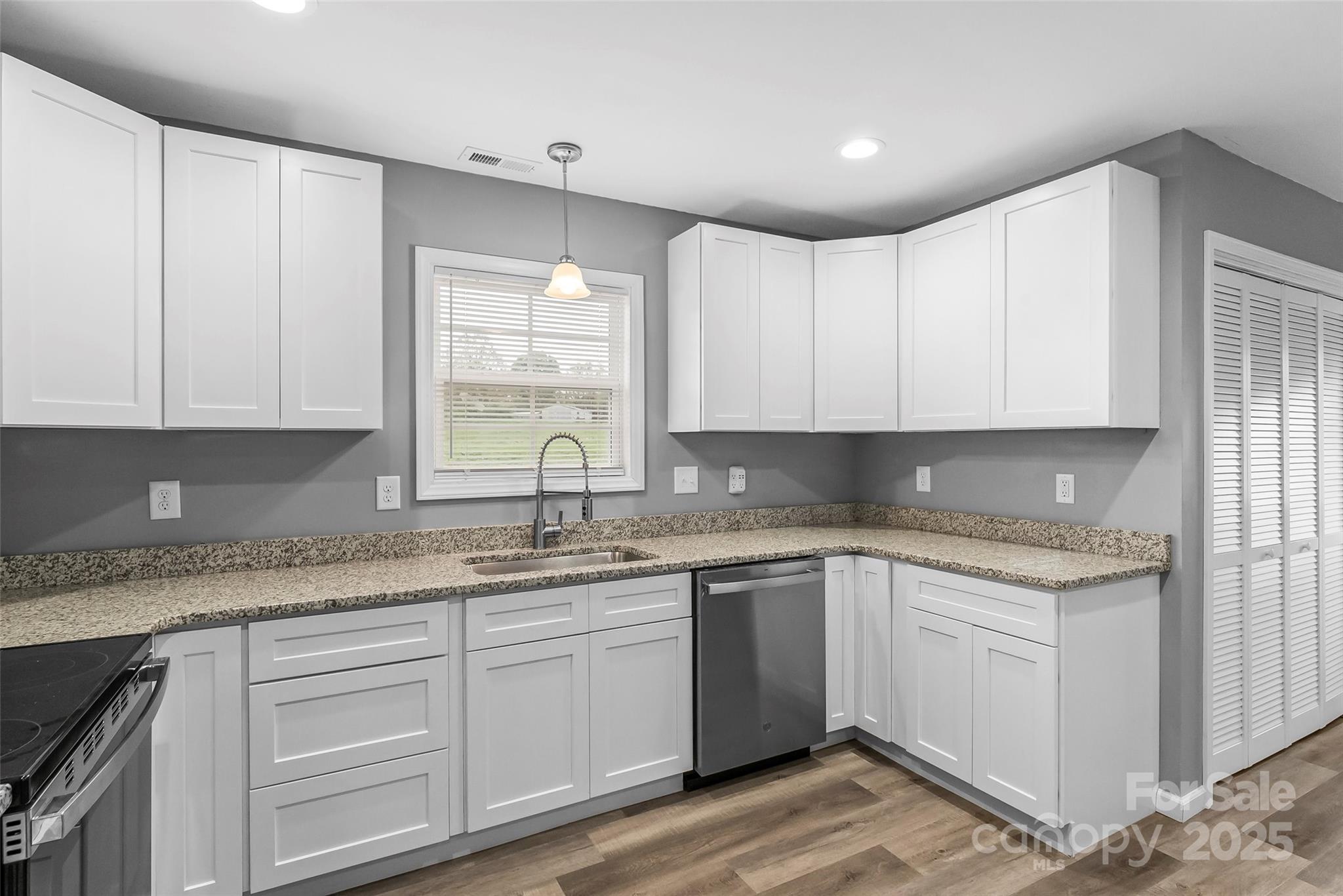391 Springs East Road Lincolnton, NC 28092 - Photo 12 of 26 a kitchen with a sink window and cabinets