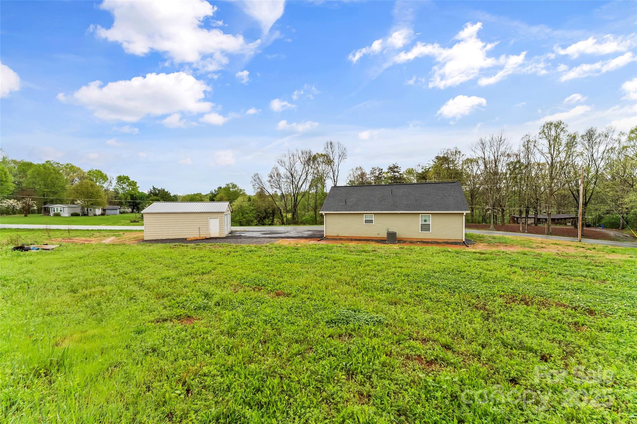 391 Springs East Road Lincolnton, NC 28092 - Photo 22 of 26 a view of a big yard next to a building