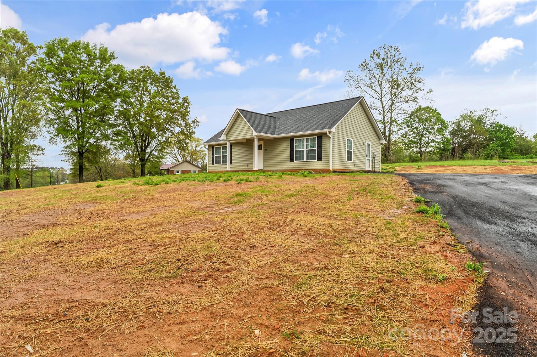 391 Springs East Road Lincolnton, NC 28092 - Photo 5 of 26 a front view of a house with a yard and trees