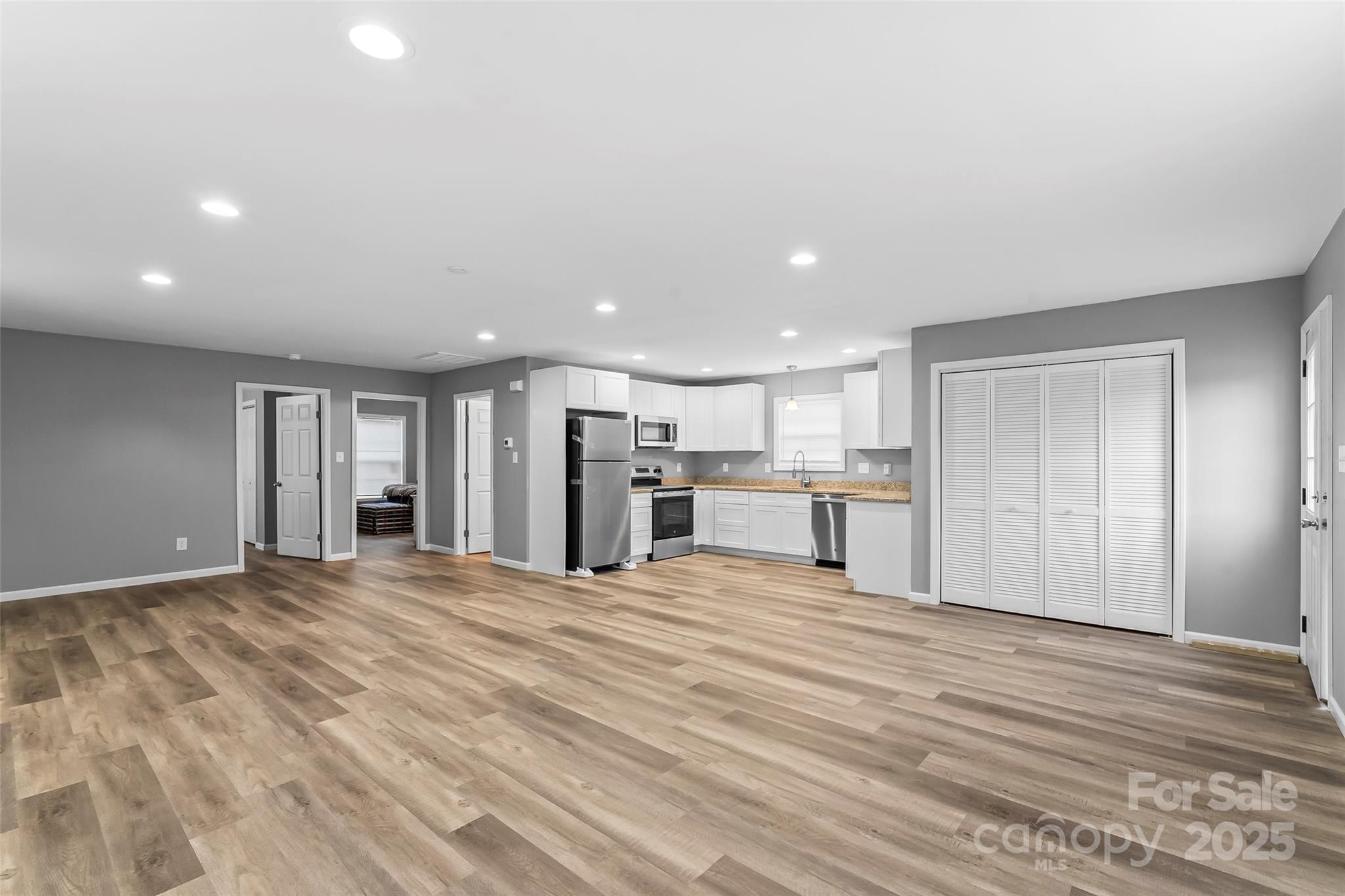 391 Springs East Road Lincolnton, NC 28092 - Photo 7 of 26 a view of an empty room with wooden floor and kitchen